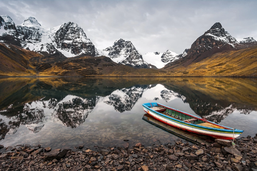 The glaciated summit of Nevado Condoriri rising above alpine lakes in the Bolivian Andes